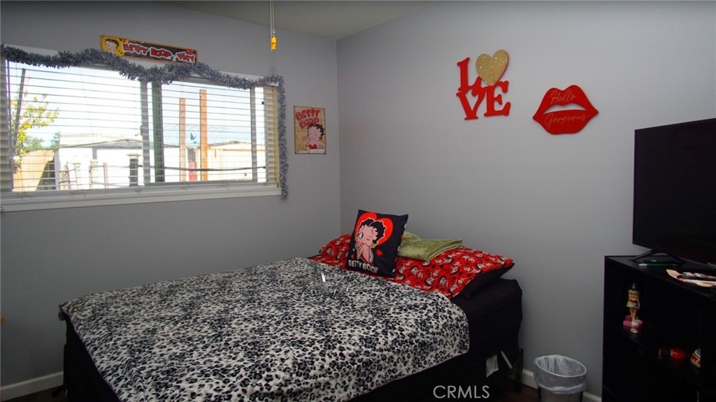 911 East Evergreen Avenue Santa Maria, CA 93454 - Photo 40 of 48 a bedroom with a bed and a chandelier