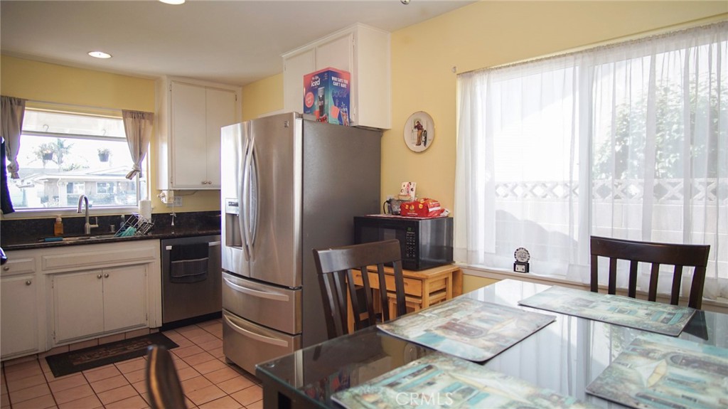 911 East Evergreen Avenue Santa Maria, CA 93454 - Photo 6 of 48 a kitchen with stainless steel appliances kitchen island granite countertop a refrigerator and a stove top oven