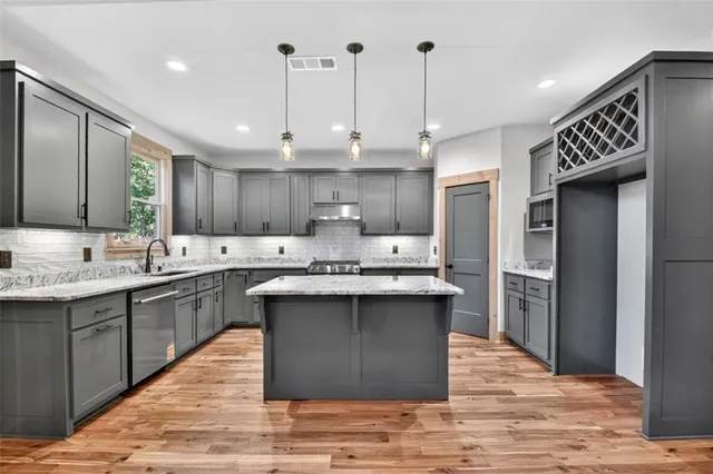 a view of kitchen with hallway and wooden floor