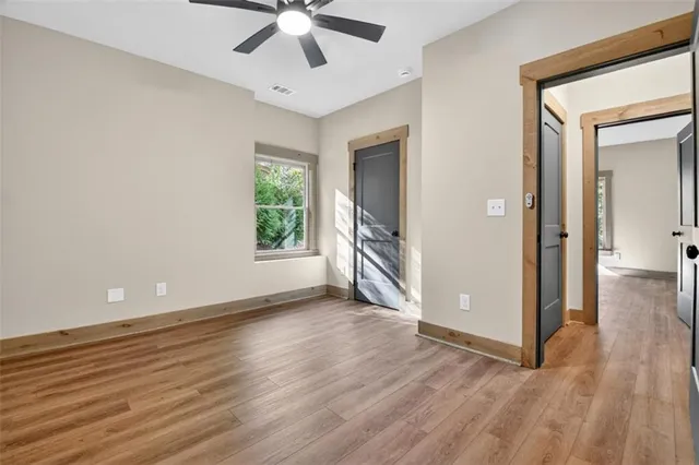 a front view of a house with large trees and a tree
