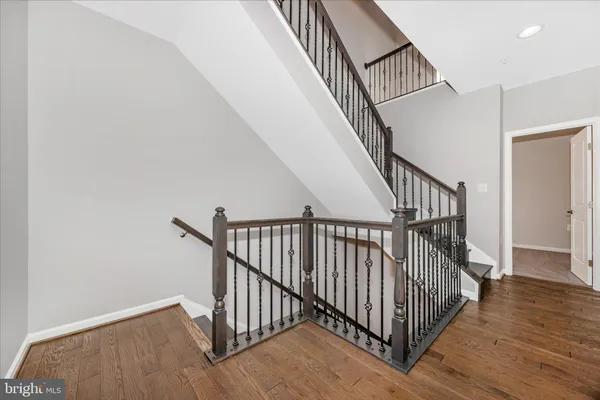 a view of staircase with railing and white walls