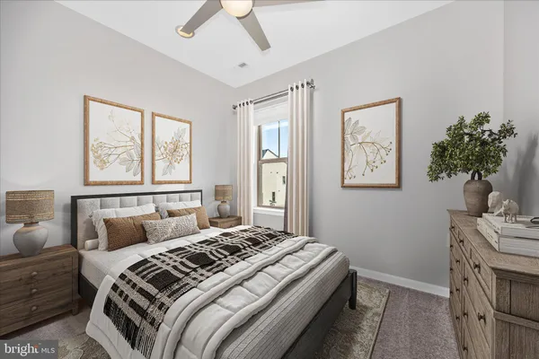 a bedroom with a bed next to a window with a potted plant on a dresser