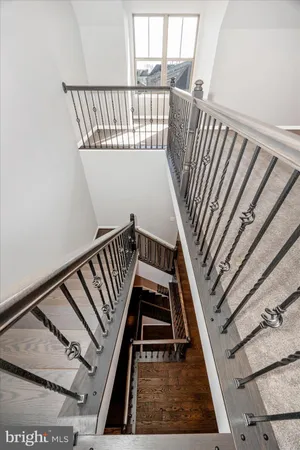 a living room with furniture a rug and a lamp