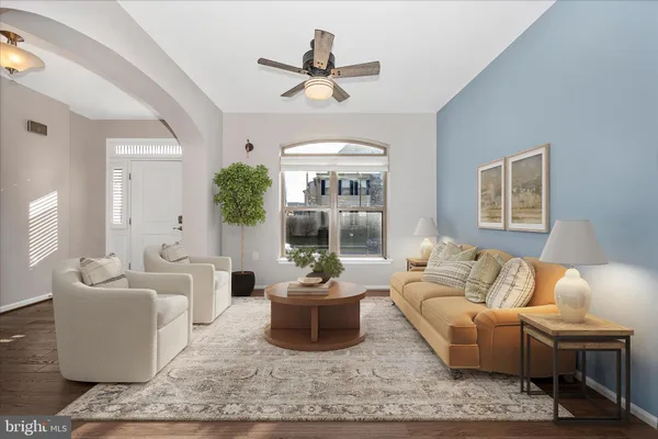 a living room with furniture a chandelier and a window