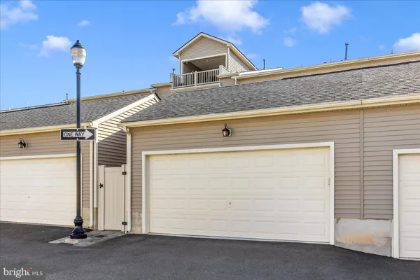 a view of a street with lots of trees and flowers