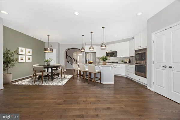 a living room with lots of furniture and kitchen view