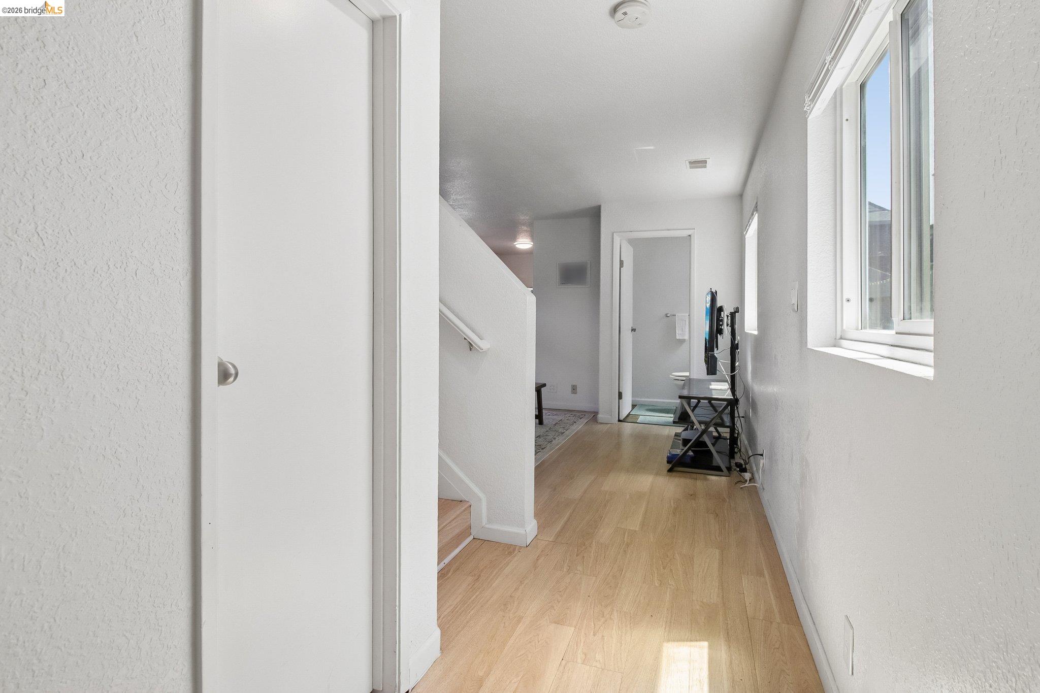 874 Pine Street Oakland, CA 94607 - Photo 4 of 39 Hallway featuring light wood-finish flooring and white painted walls