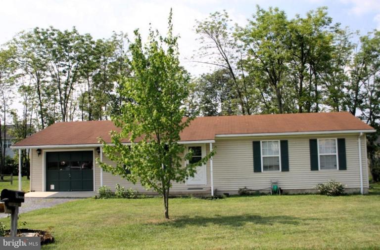92 Truman Road Inwood, WV 25428 - Photo 1 of 11 a front view of a house with a yard