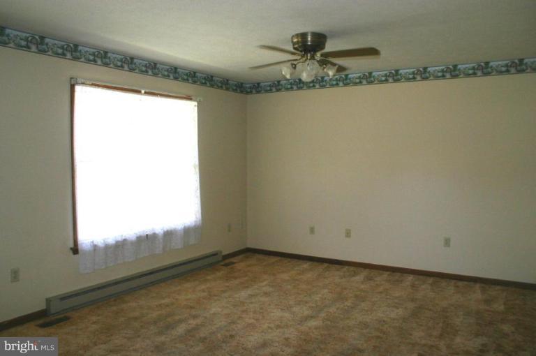 92 Truman Road Inwood, WV 25428 - Photo 7 of 11 a view of a room with rack on the wall and a window