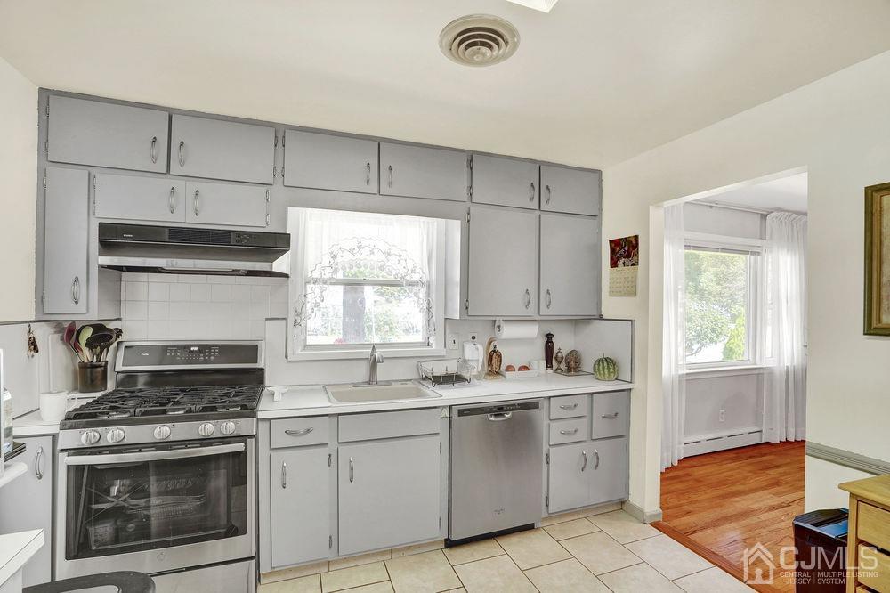 1 Sulliman Road Edison, NJ 08817 - Photo 11 of 24 a kitchen with a stove sink and cabinets