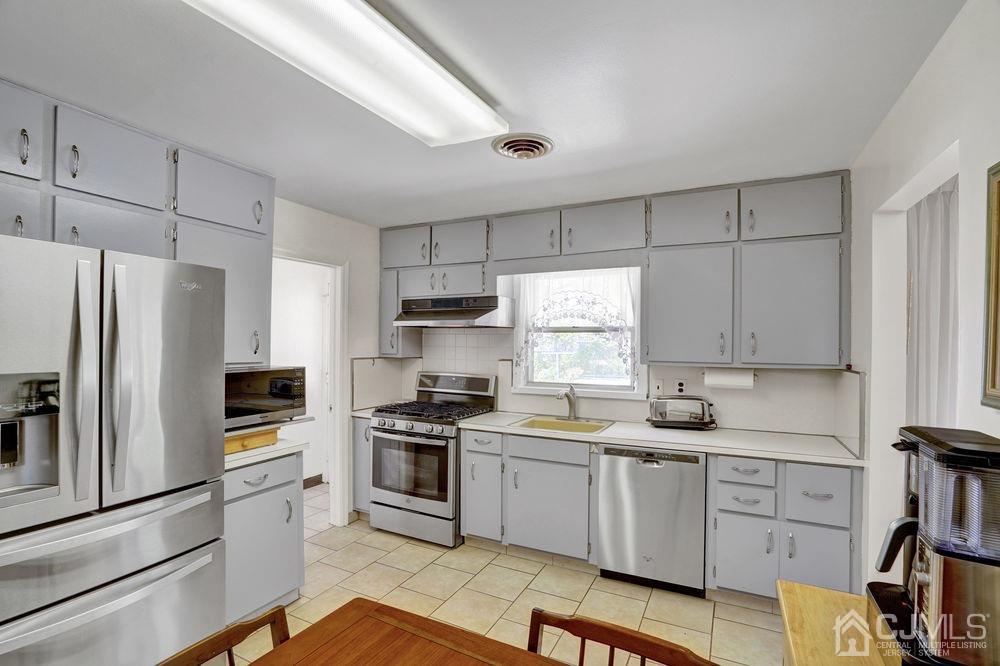 1 Sulliman Road Edison, NJ 08817 - Photo 12 of 24 a kitchen with white cabinets and stainless steel appliances