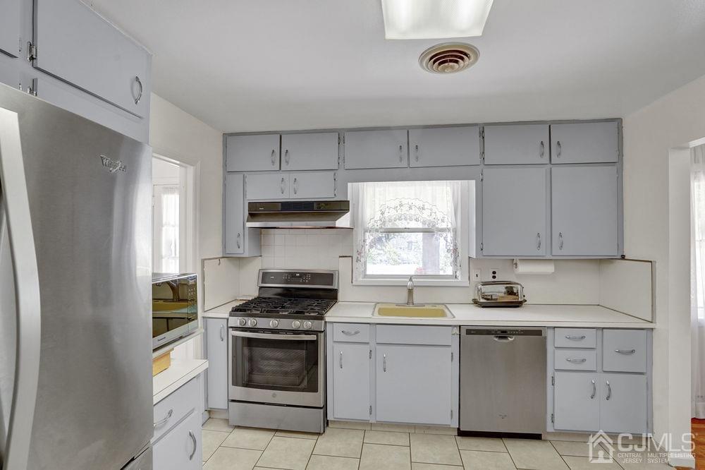 1 Sulliman Road Edison, NJ 08817 - Photo 13 of 24 a kitchen with white cabinets and white appliances