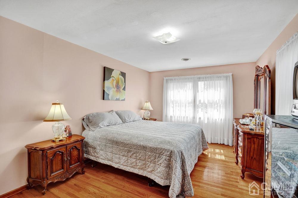 1 Sulliman Road Edison, NJ 08817 - Photo 14 of 24 a bedroom with a bed and wooden floor