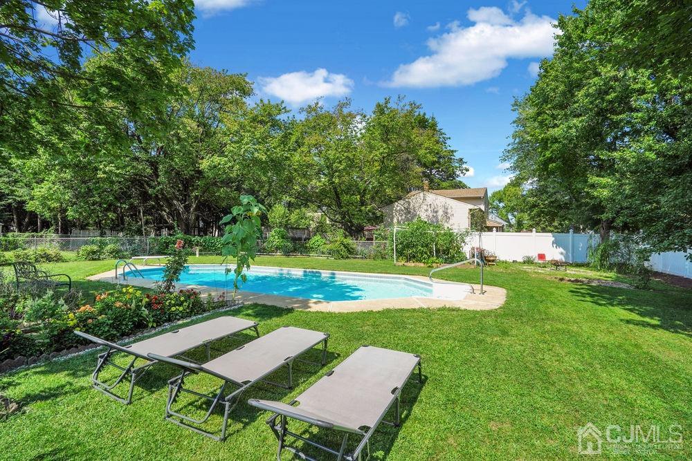1 Sulliman Road Edison, NJ 08817 - Photo 21 of 24 a view of a big yard with swimming pool and green space