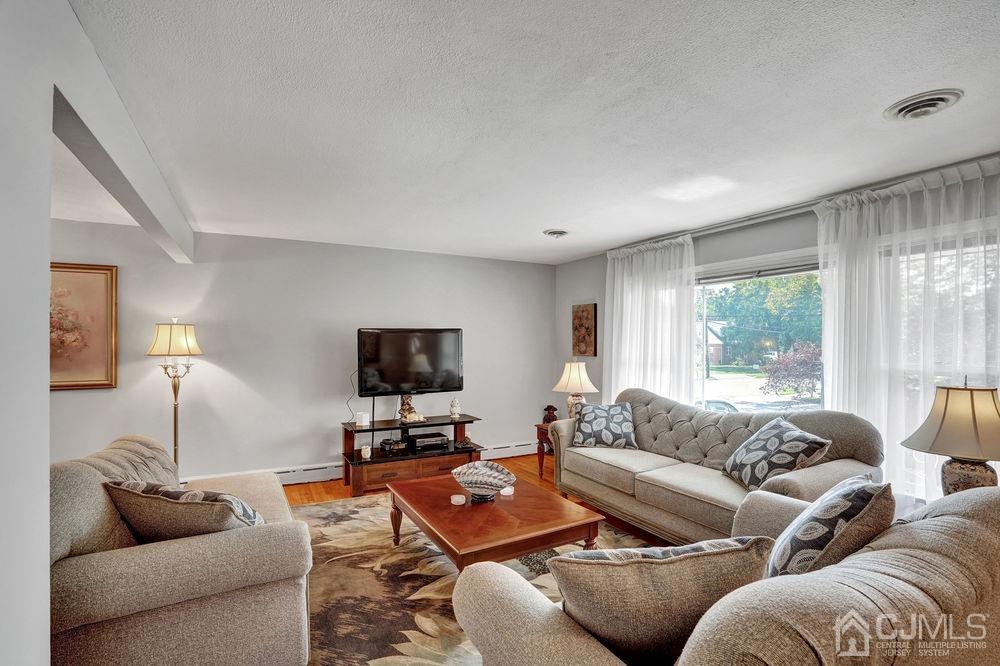 1 Sulliman Road Edison, NJ 08817 - Photo 5 of 24 a living room with furniture and a flat screen tv