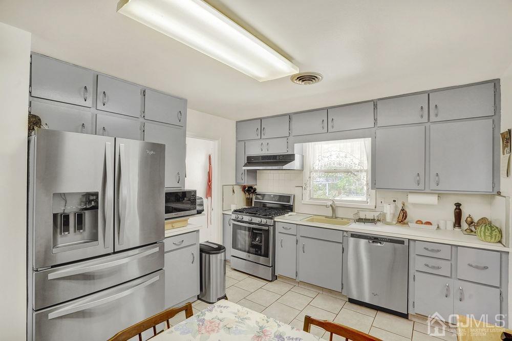 1 Sulliman Road Edison, NJ 08817 - Photo 9 of 24 a kitchen with a refrigerator sink and cabinets