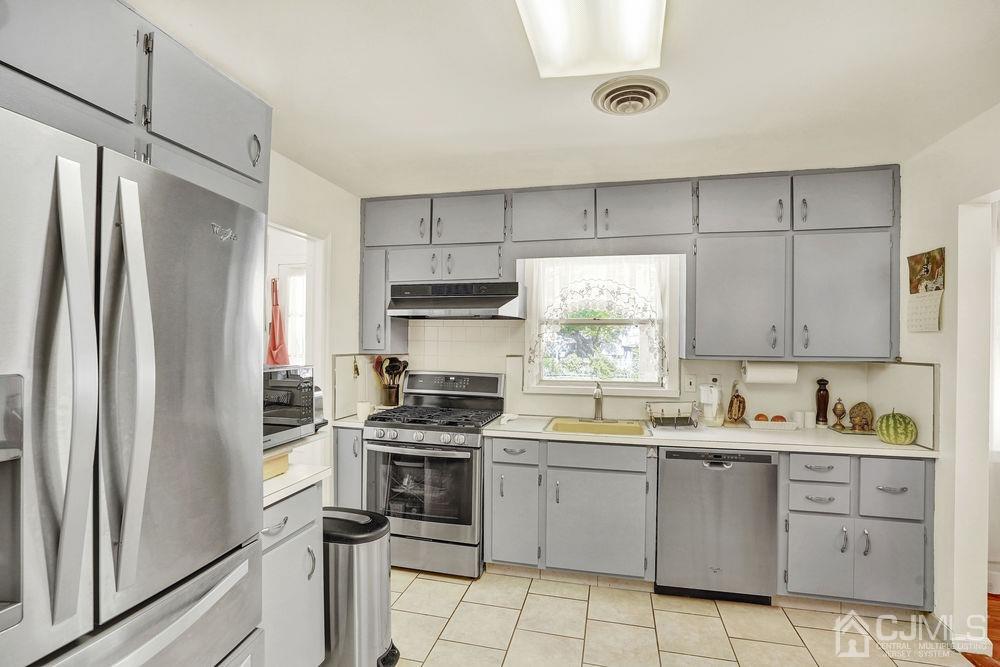1 Sulliman Road Edison, NJ 08817 - Photo 10 of 24 a kitchen with white cabinets stainless steel appliances and a window