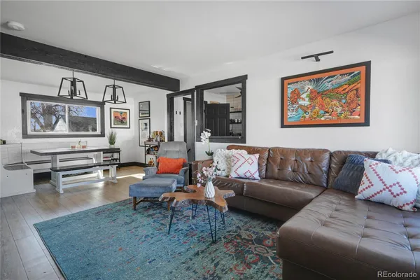 a living room with furniture and wooden floor