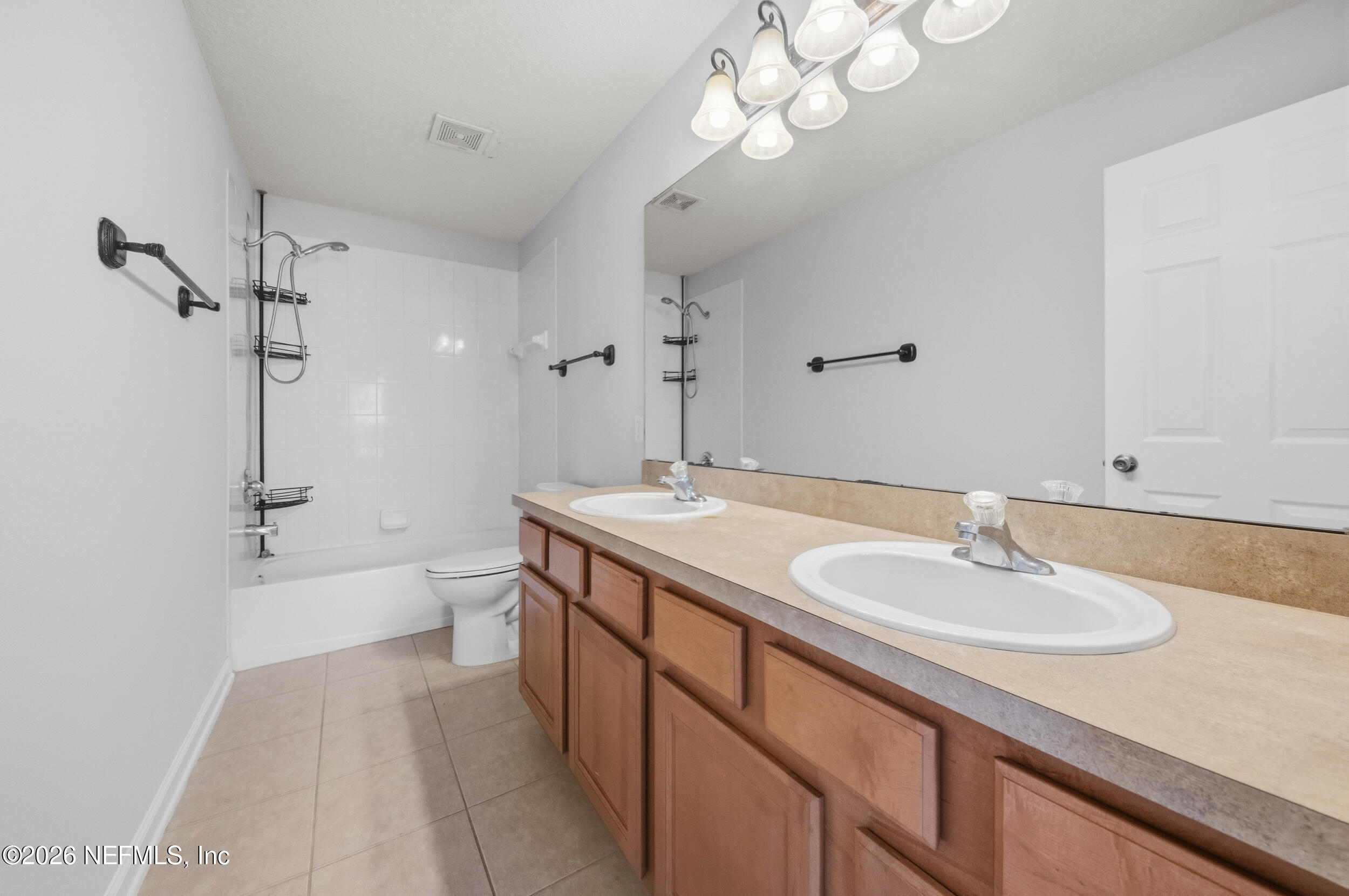 6700 Bowden Road, Unit 1004 Jacksonville, FL 32216 - Photo 16 of 25 a bathroom with a sink a toilet and a mirror