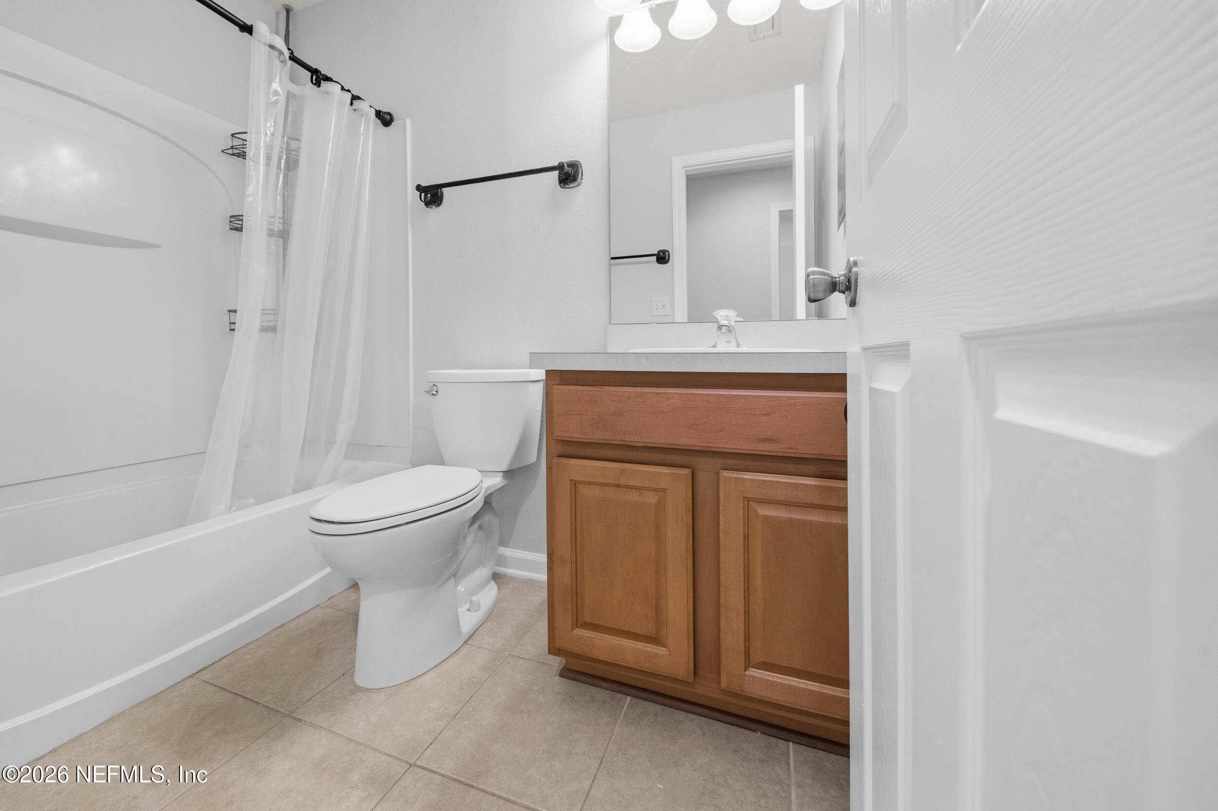6700 Bowden Road, Unit 1004 Jacksonville, FL 32216 - Photo 19 of 25 a bathroom with a toilet sink and a mirror