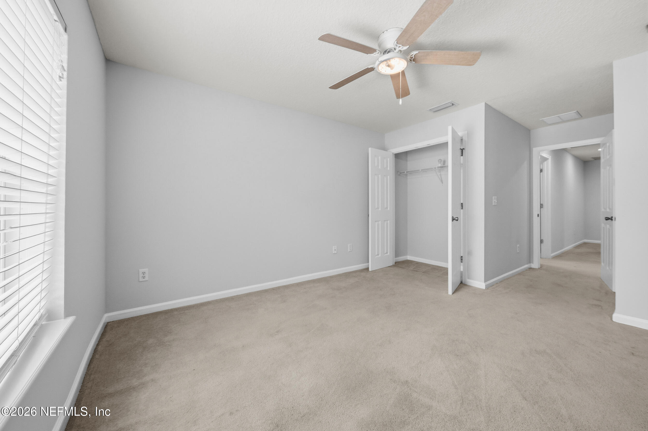 6700 Bowden Road, Unit 1004 Jacksonville, FL 32216 - Photo 21 of 25 an empty room with windows and fan