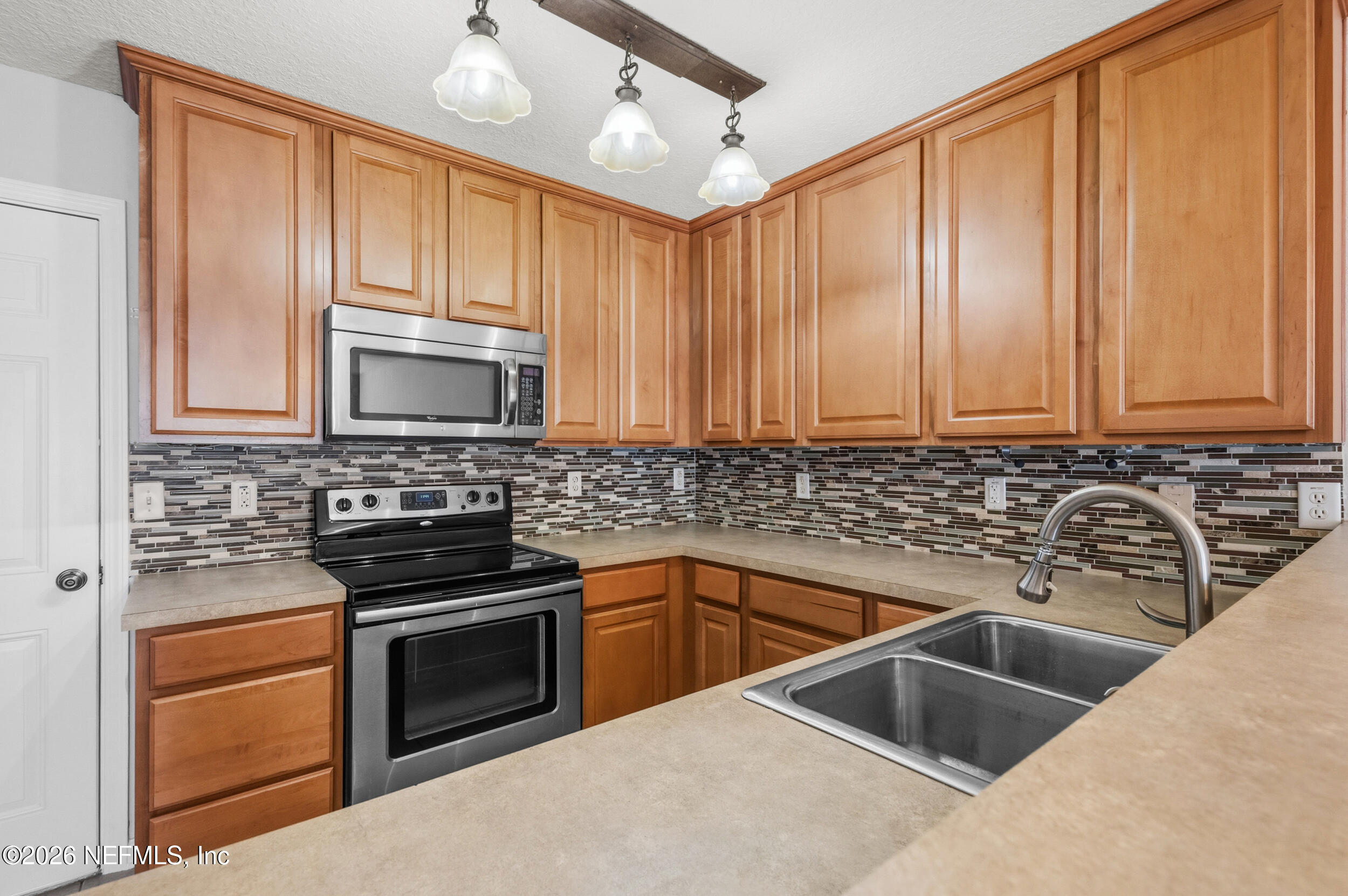 6700 Bowden Road, Unit 1004 Jacksonville, FL 32216 - Photo 6 of 25 a kitchen with granite countertop a sink stove and cabinets