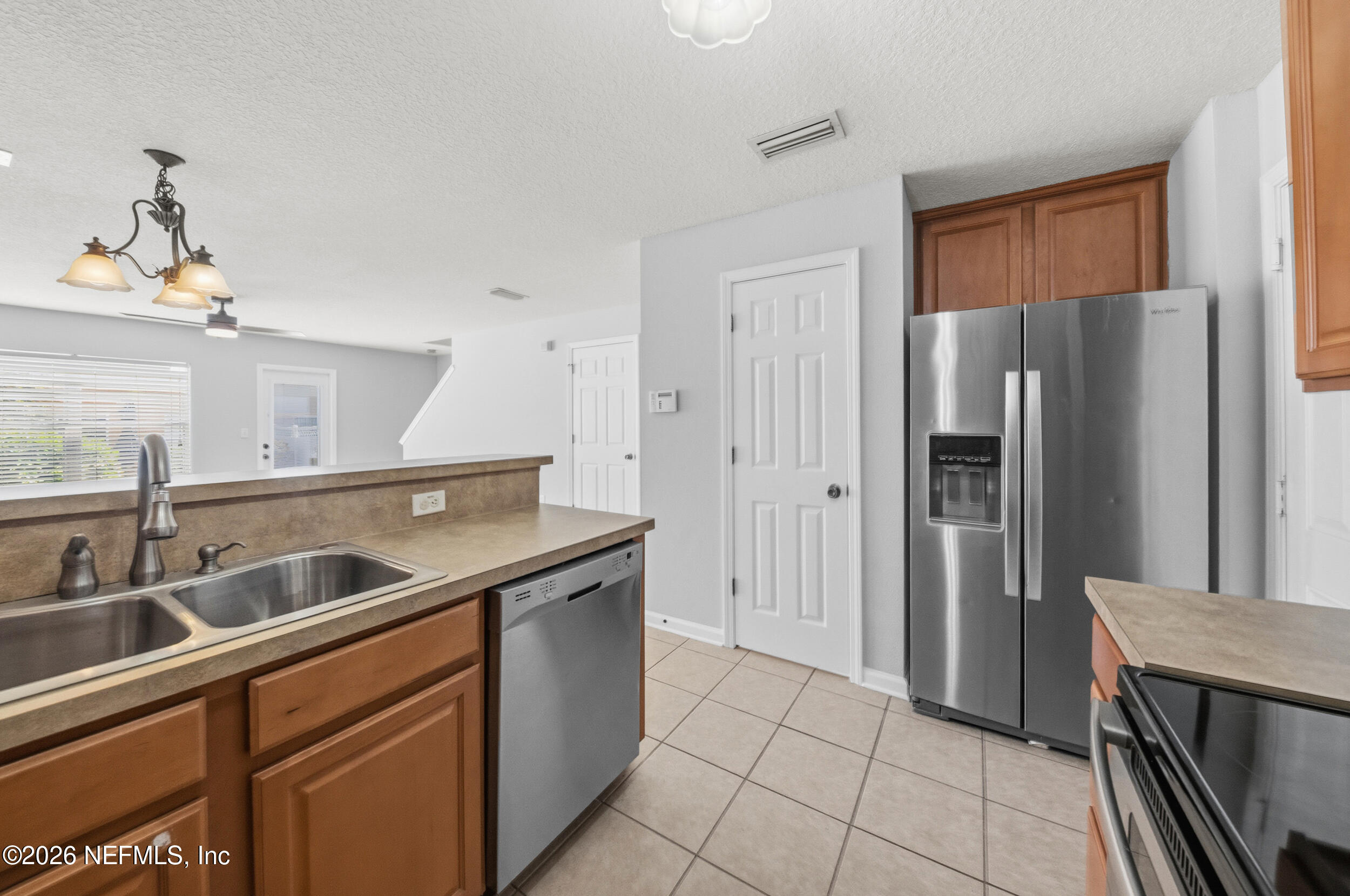 6700 Bowden Road, Unit 1004 Jacksonville, FL 32216 - Photo 9 of 25 a kitchen with a sink and refrigerator