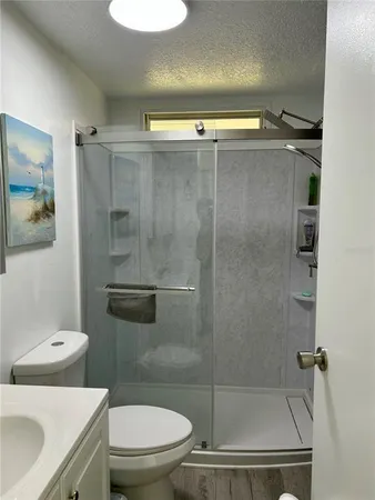 a bathroom with a shower a toilet and a sink