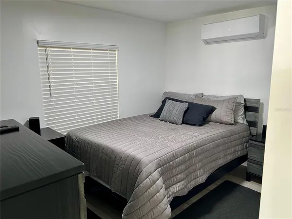 a bedroom with two beds and a night stand