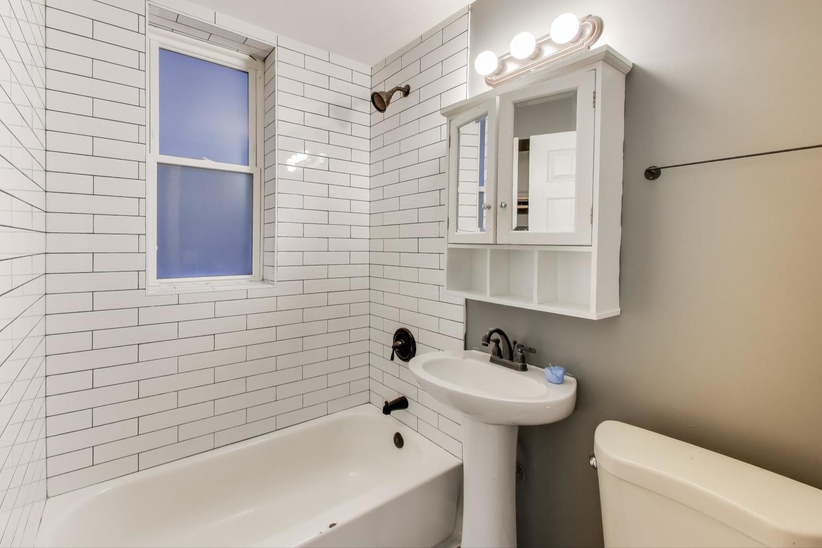 6624 South Rhodes Avenue Chicago, IL 60637 - Photo 14 of 23 a bathroom with a sink a toilet and shower