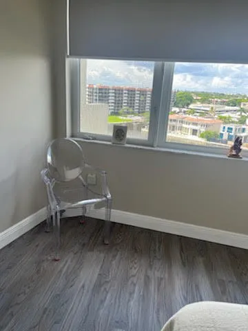 a living room with a window and wooden floor