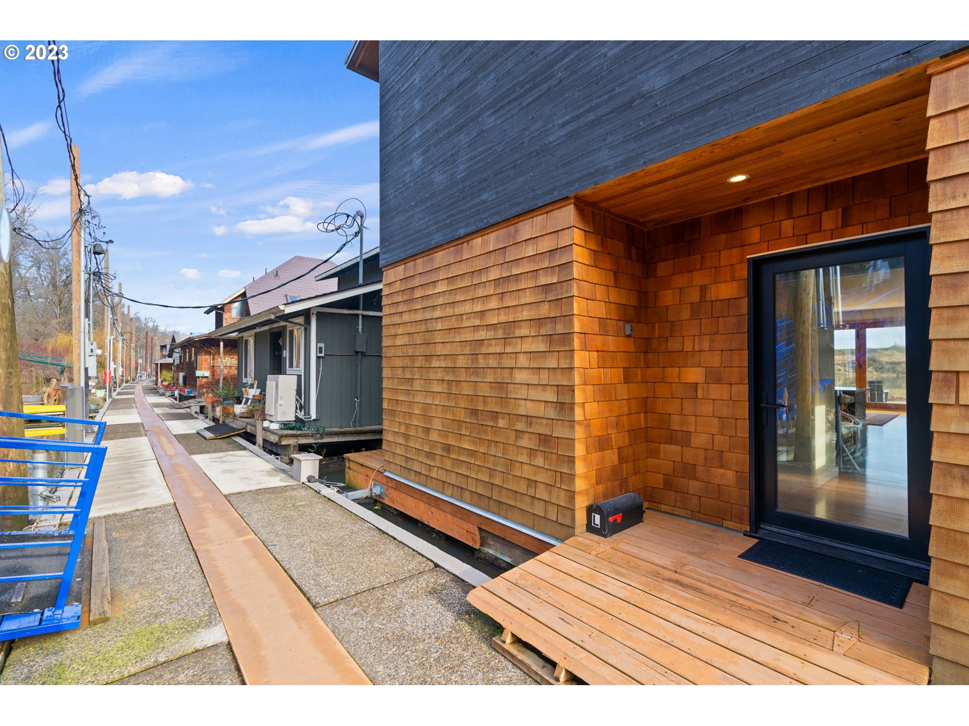 14974 Northwest Mill Road Portland, OR 97231 - Photo 7 of 29 a view of a patio with table and chairs with wooden floor and floor to ceiling window