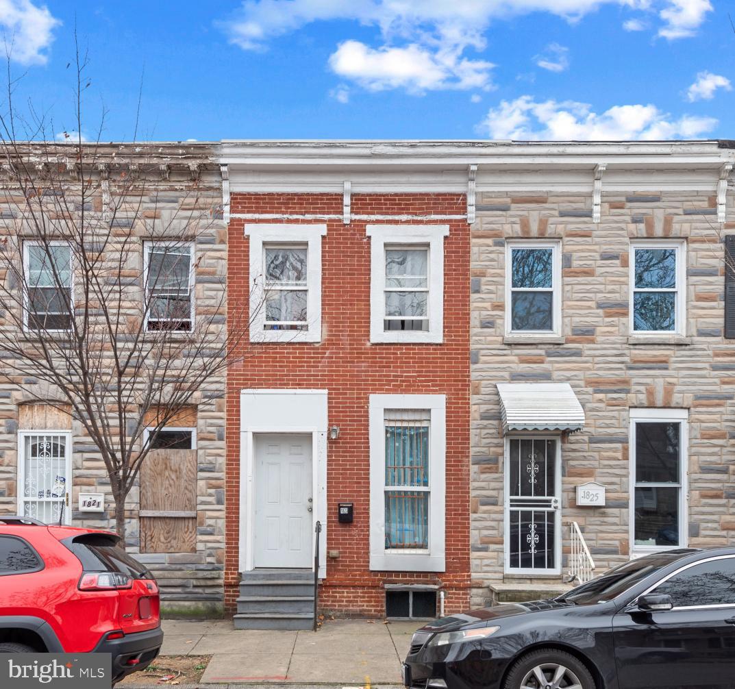 1823 Ramsay Street Baltimore, MD 21223 - Photo 1 of 19 a front view of a building with parking space