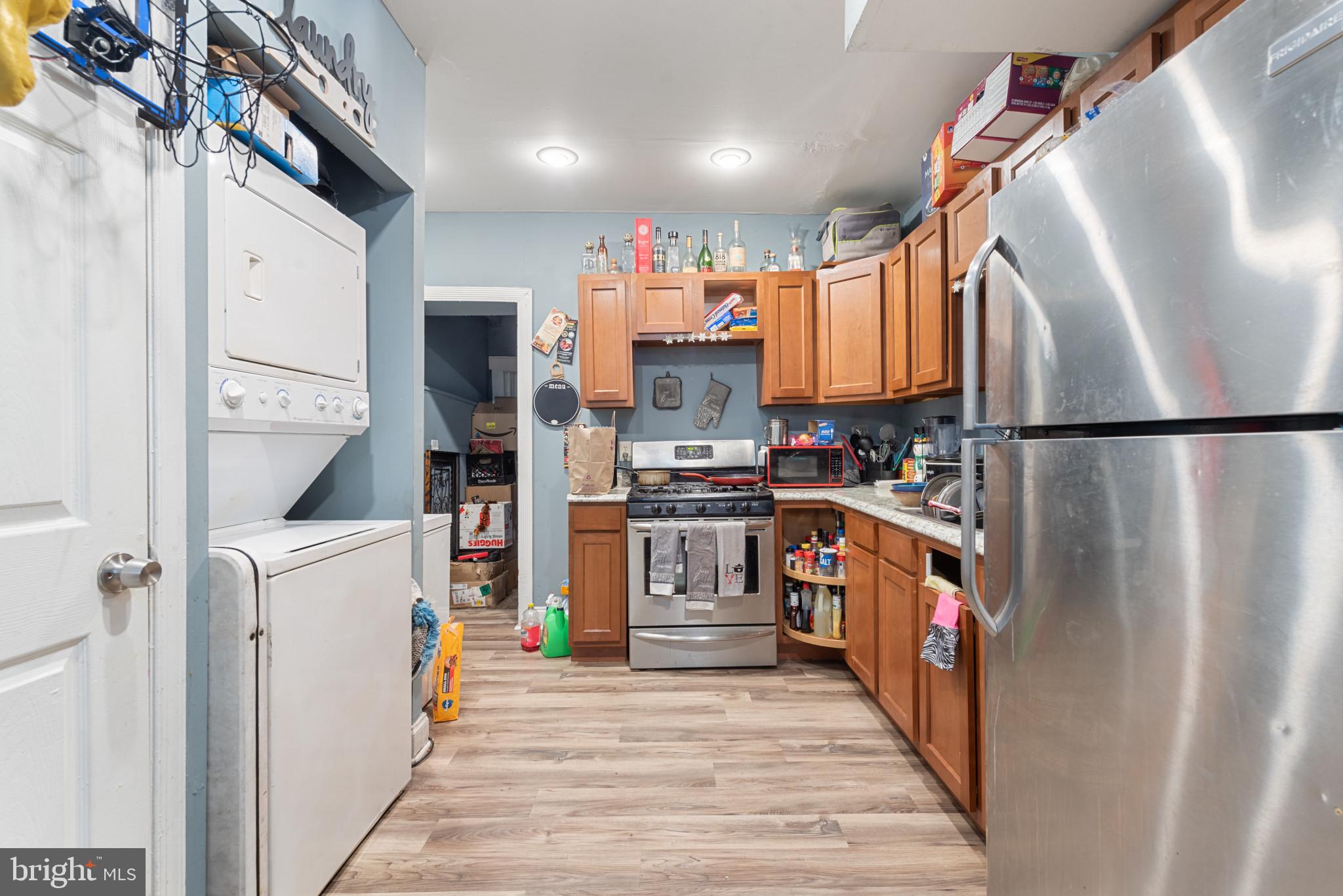 1823 Ramsay Street Baltimore, MD 21223 - Photo 11 of 19 a kitchen with stainless steel appliances granite countertop a refrigerator and a stove