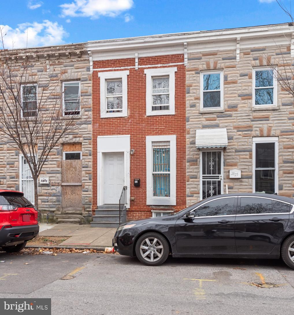 1823 Ramsay Street Baltimore, MD 21223 - Photo 3 of 19 a car parked in front of a house