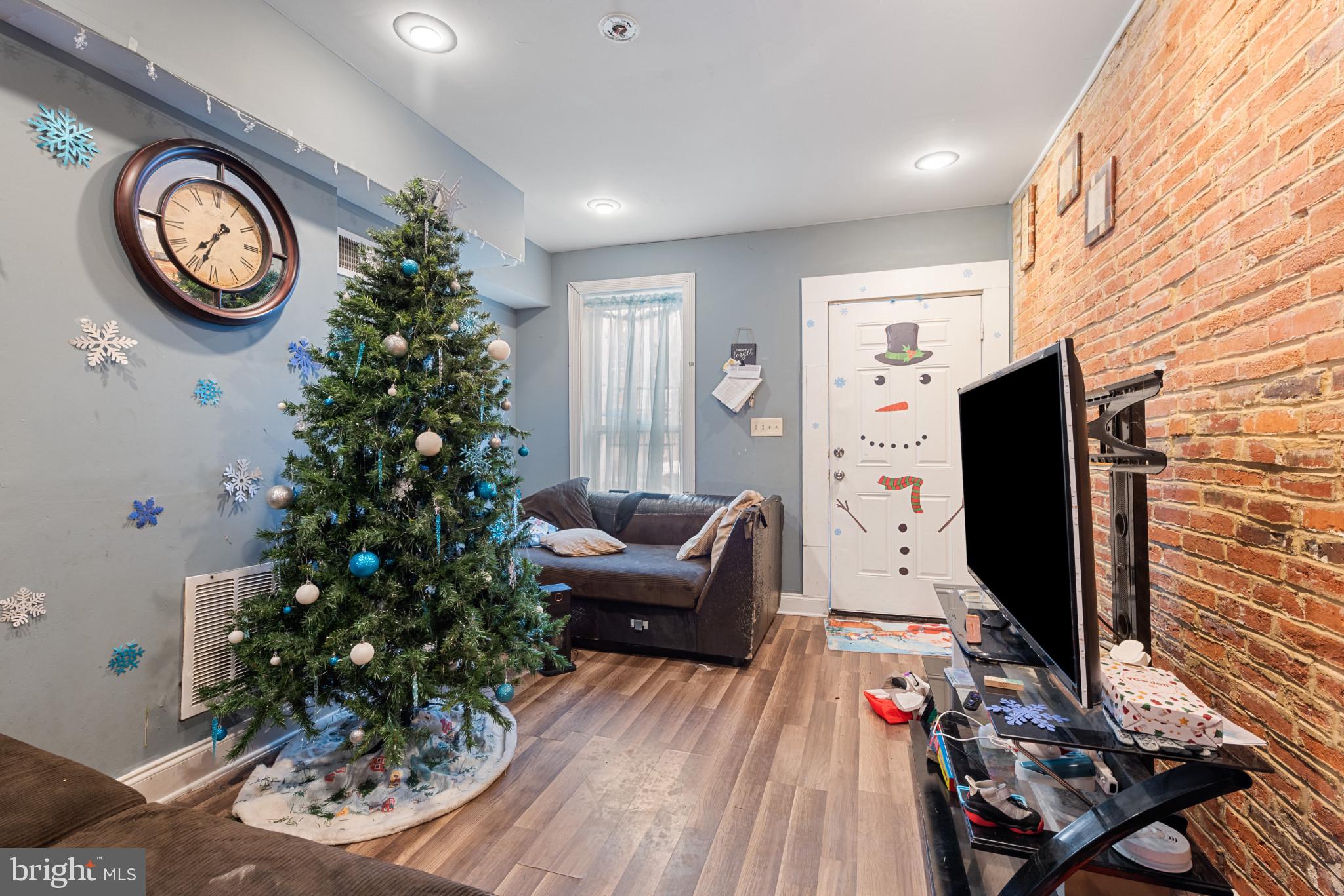 1823 Ramsay Street Baltimore, MD 21223 - Photo 6 of 19 a living room with furniture and a flat screen tv