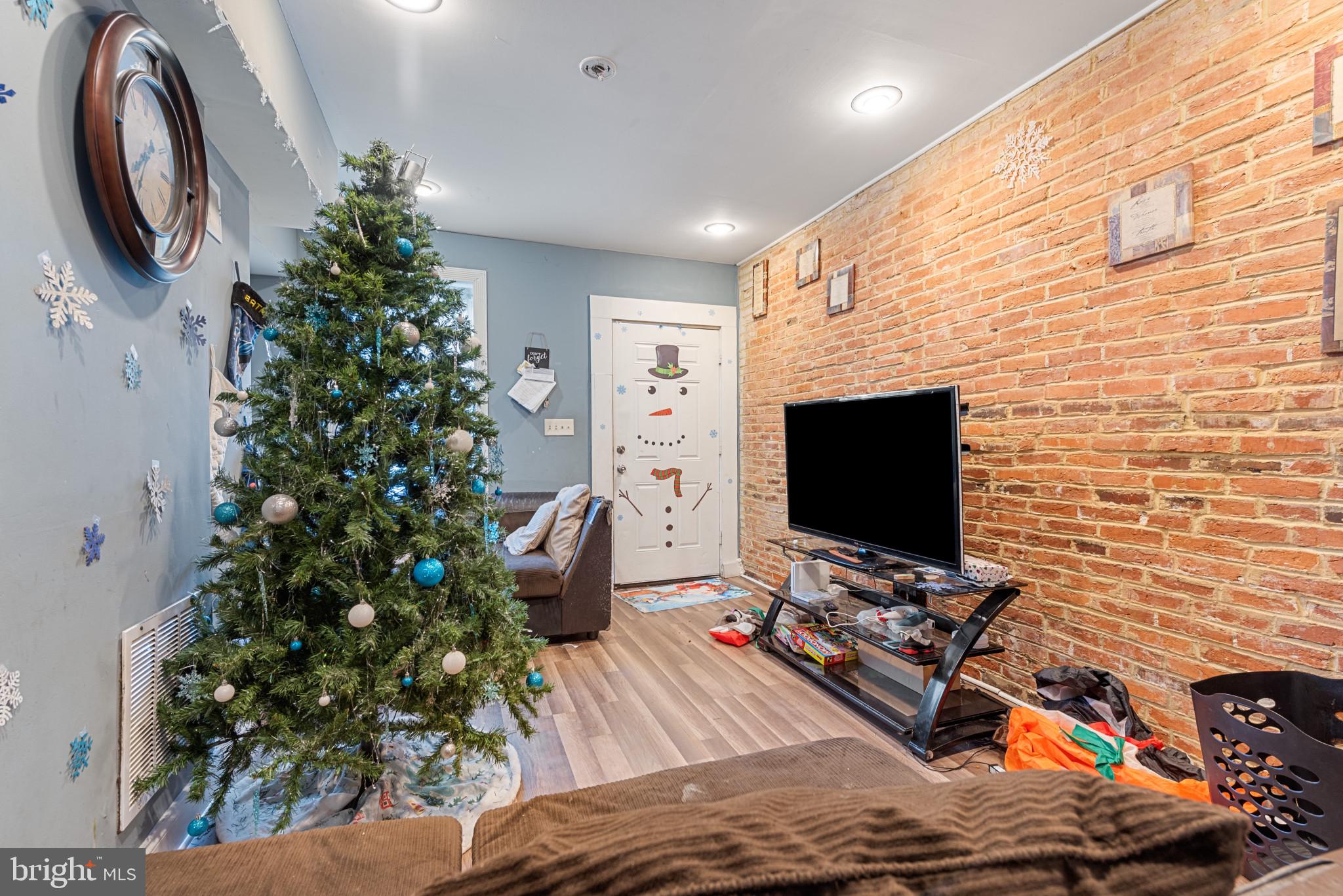 1823 Ramsay Street Baltimore, MD 21223 - Photo 7 of 19 a living room with furniture and a flat screen tv