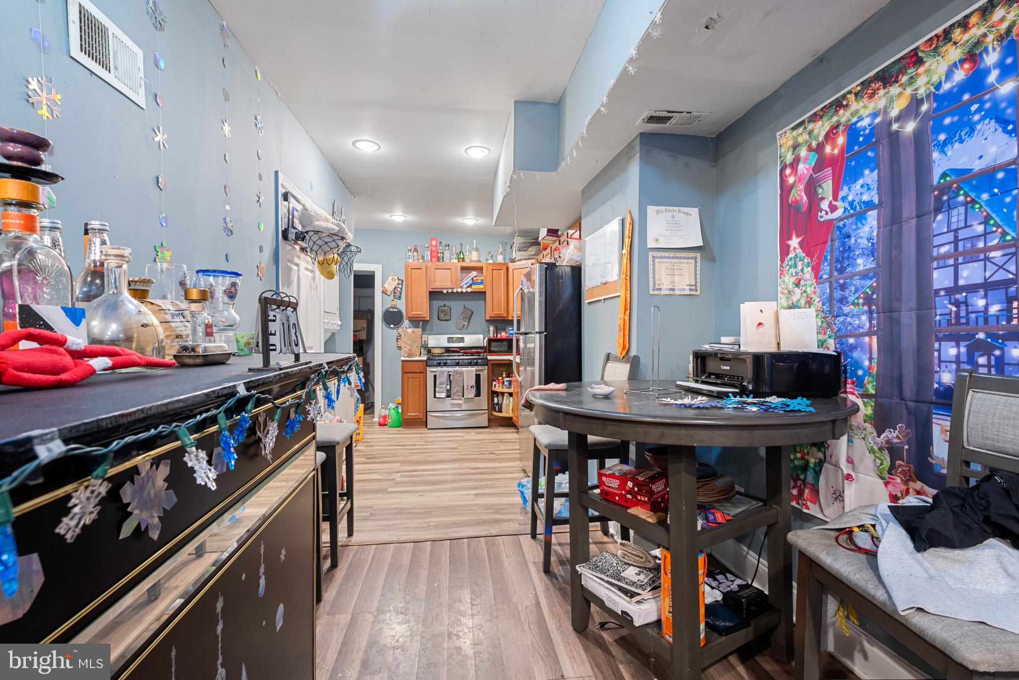 1823 Ramsay Street Baltimore, MD 21223 - Photo 10 of 19 a view of a kitchen with stainless steel appliances granite countertop a stove and a dining table