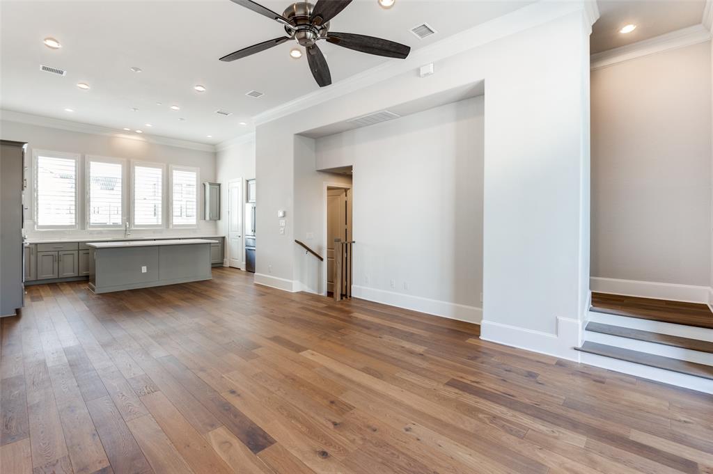 5421 Patterson Street Irving, TX 75039 - Photo 21 of 32 Expansive open concept interior featuring wood-finish flooring, a contemporary ceiling fan, recessed lighting, and crown molding
