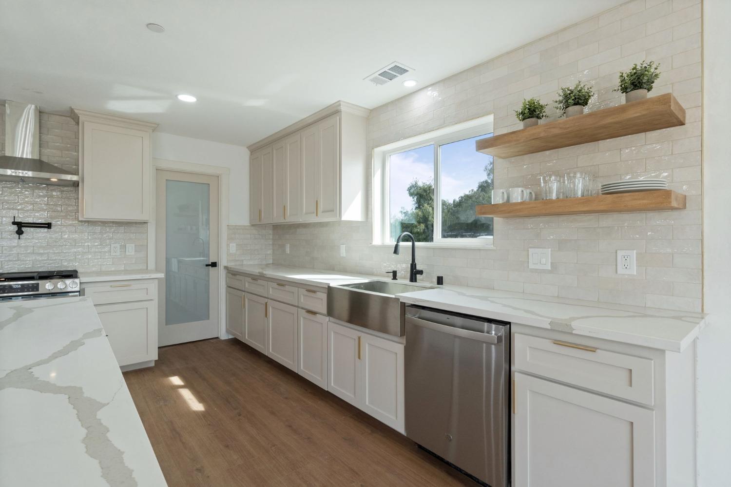 25918 Tanforan Drive Madera, CA 93638 - Photo 17 of 37 a kitchen with a sink stove and cabinets