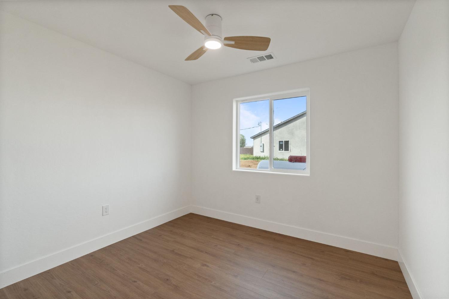 25918 Tanforan Drive Madera, CA 93638 - Photo 25 of 37 wooden floor in an empty room with a window
