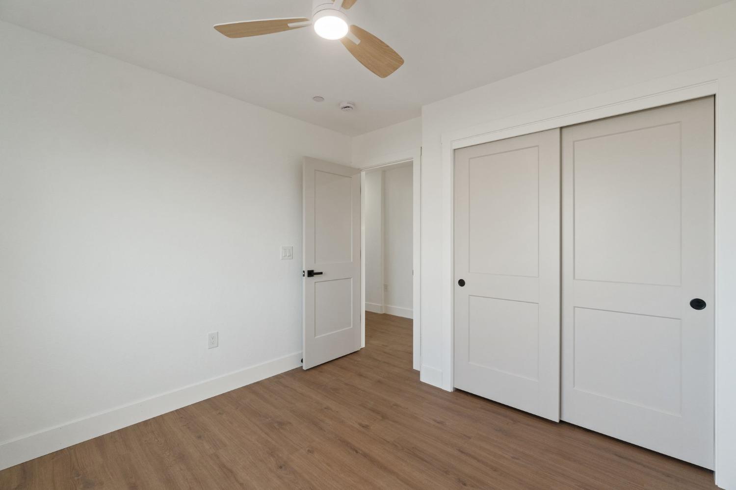 25918 Tanforan Drive Madera, CA 93638 - Photo 26 of 37 a view of an empty room with wooden floor