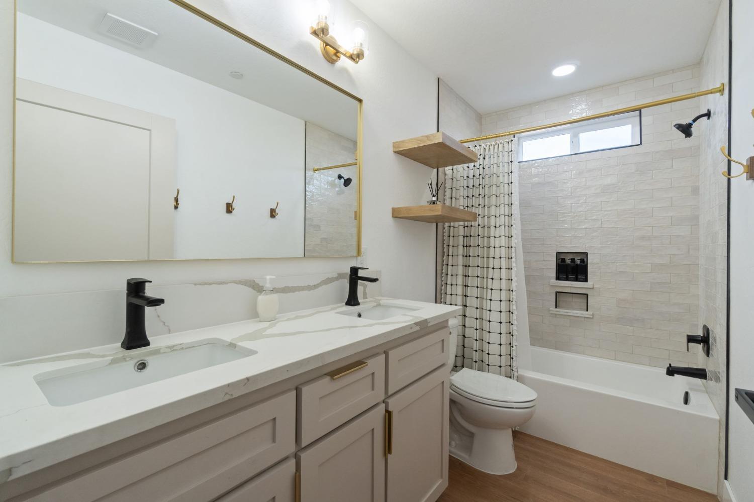 25918 Tanforan Drive Madera, CA 93638 - Photo 28 of 37 a bathroom with a sink a toilet and shower