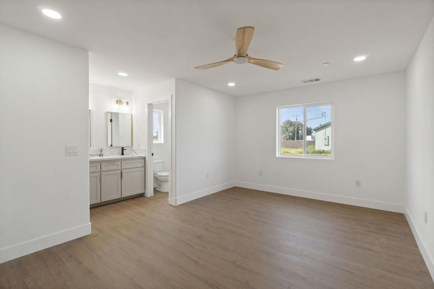 25918 Tanforan Drive Madera, CA 93638 - Photo 29 of 37 wooden floor in an empty room with a window