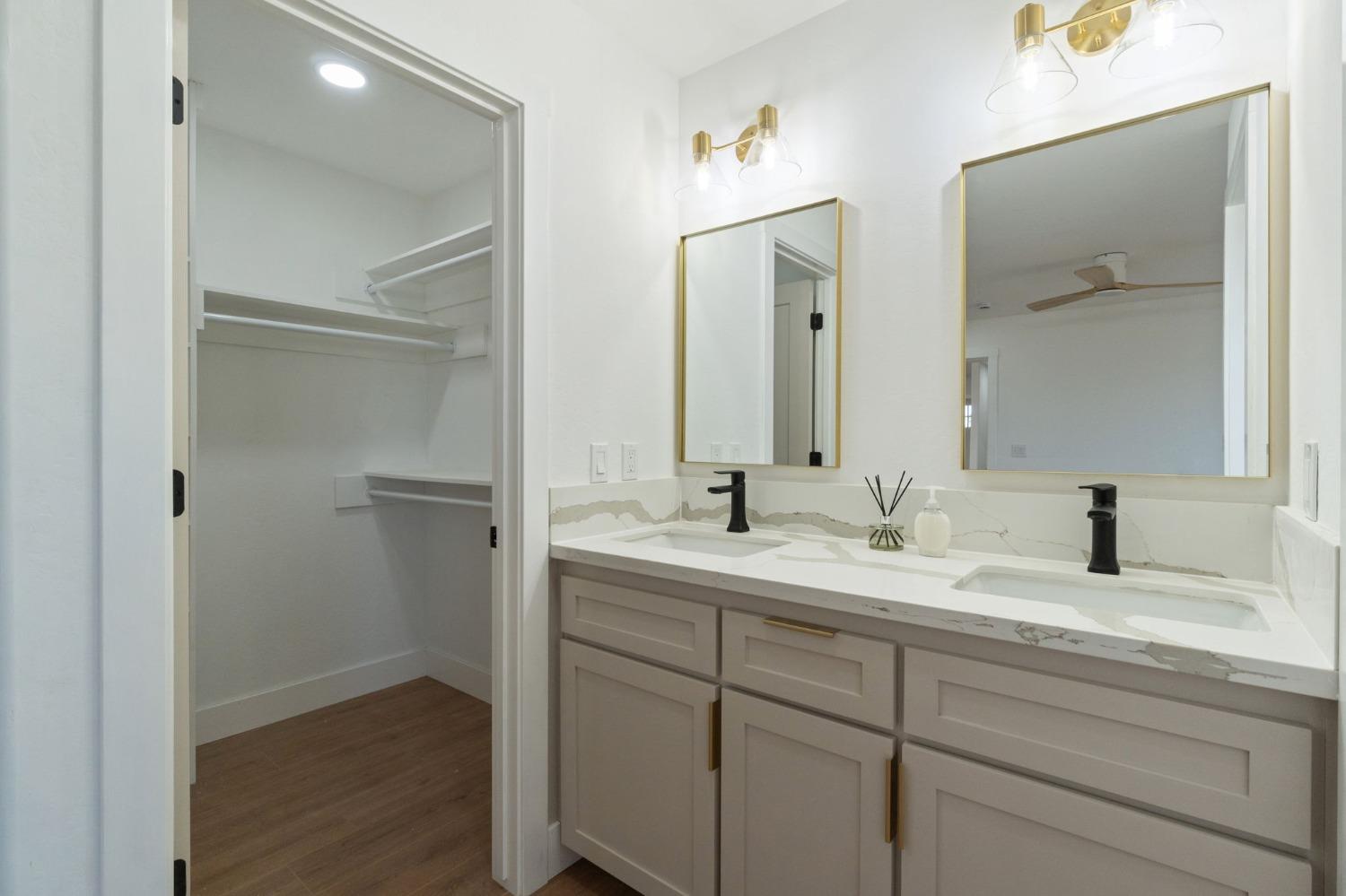 25918 Tanforan Drive Madera, CA 93638 - Photo 32 of 37 a bathroom with a granite countertop sink double and mirror