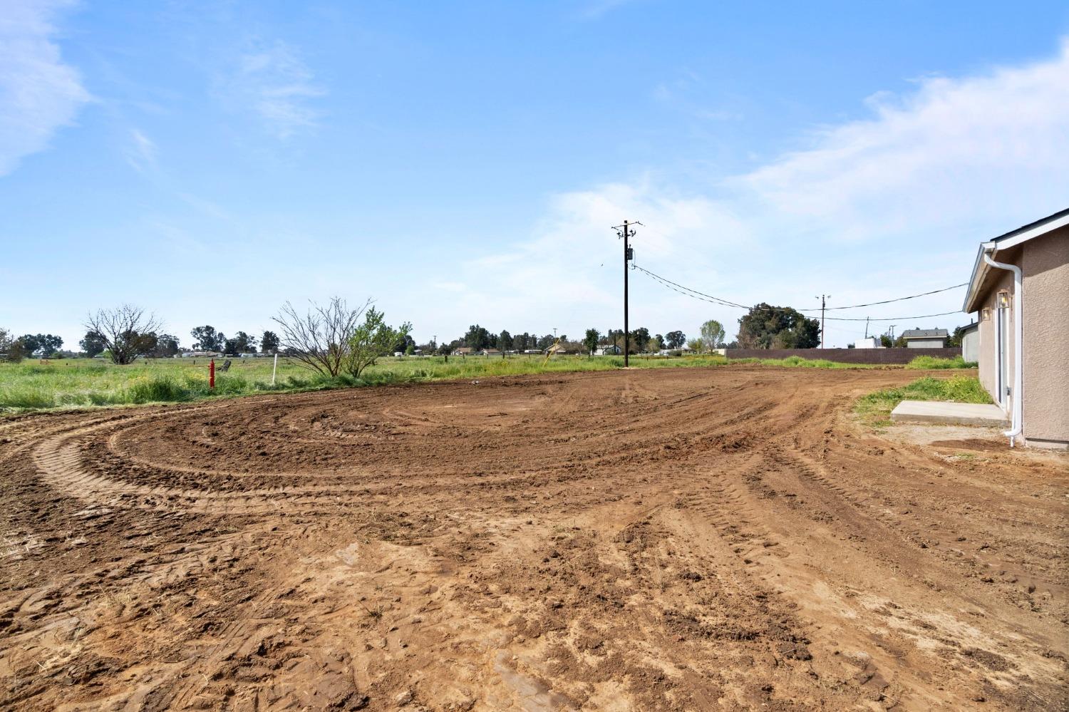 25918 Tanforan Drive Madera, CA 93638 - Photo 33 of 37 a view of a lake with houses in the background