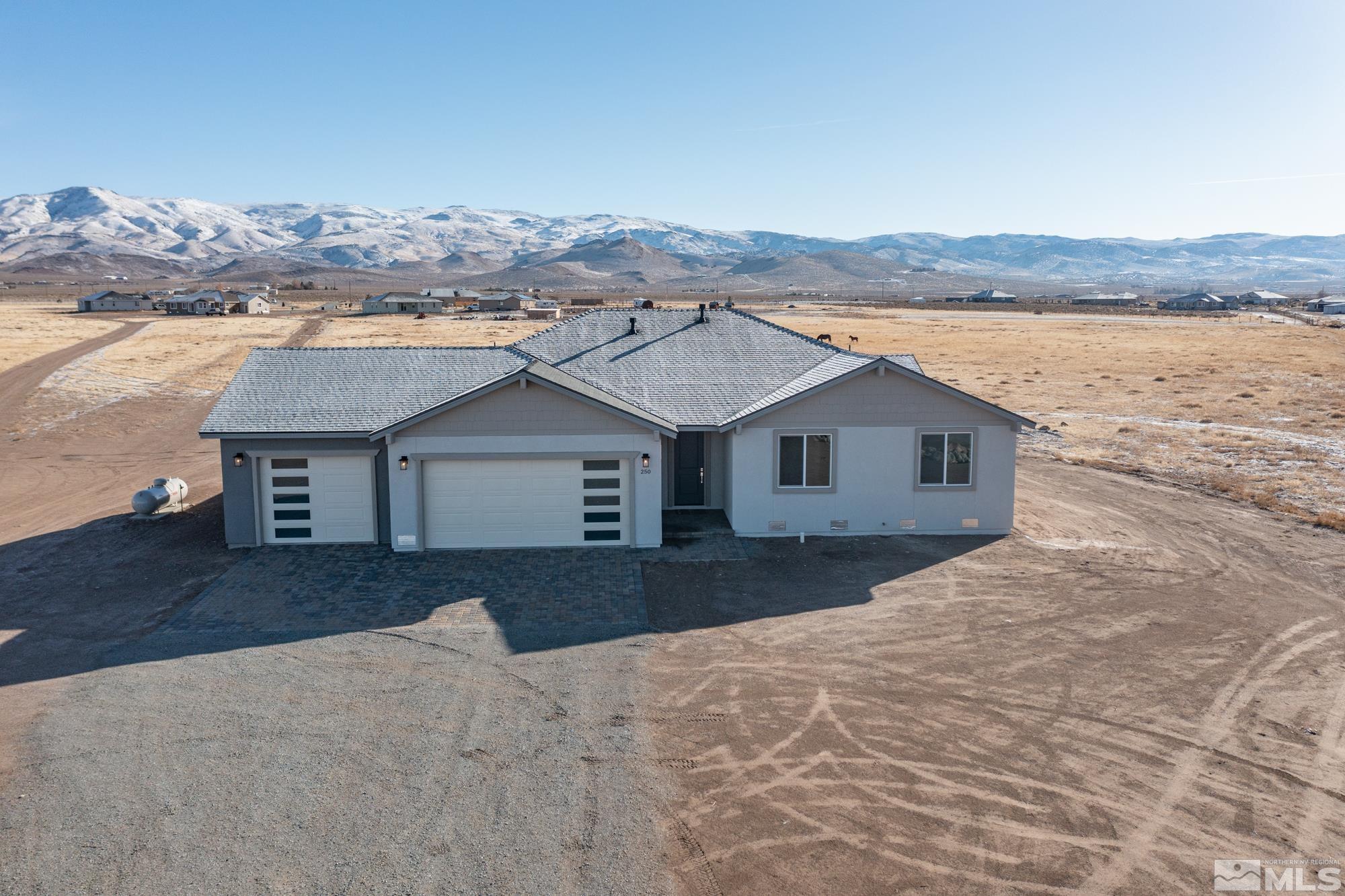 250 Paloma Ranch Court Reno, NV 89510 - Photo 2 of 35 a front view of a house with a yard and mountain view