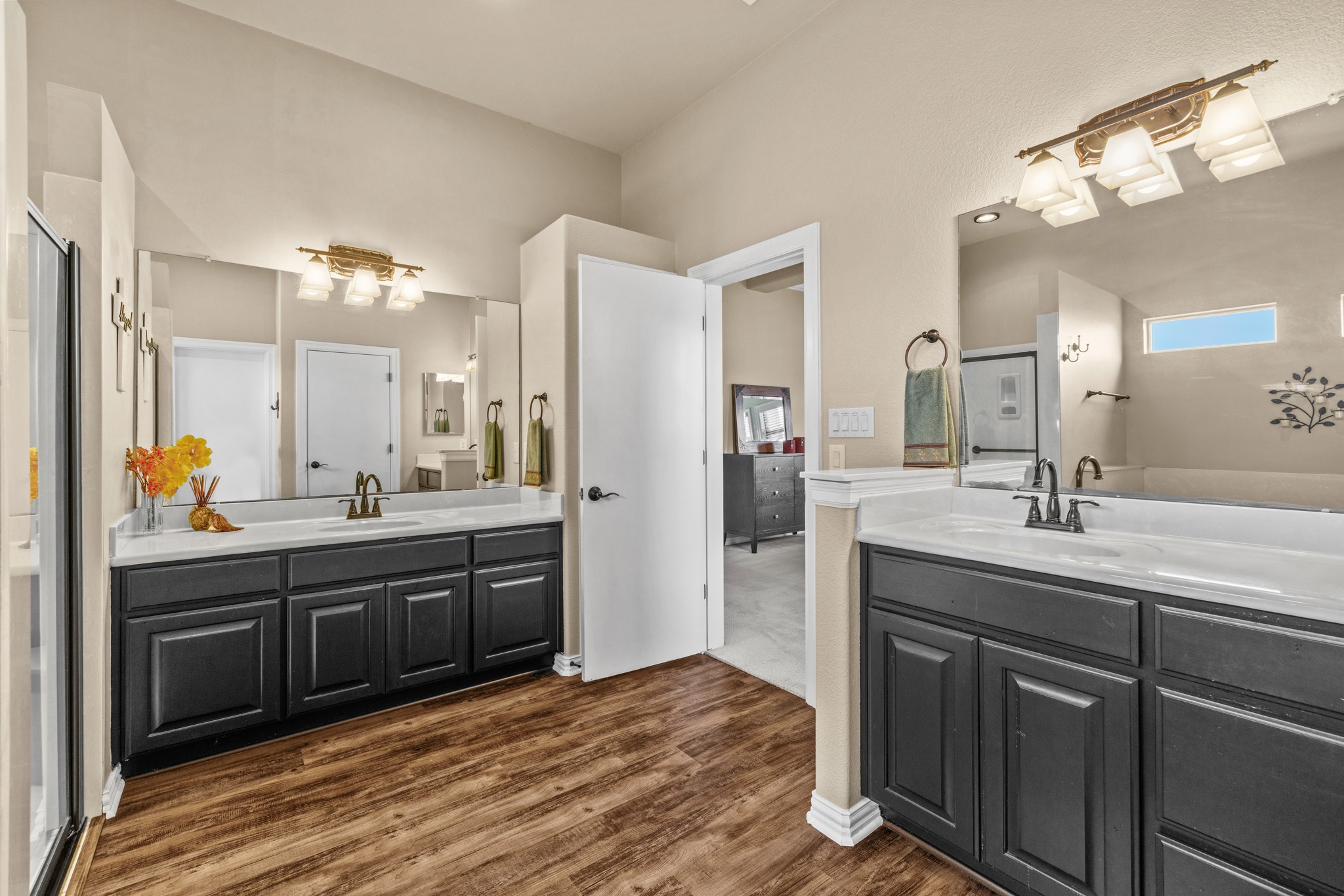 204 Skyline Road Georgetown, TX 78628 - Photo 21 of 40 Bathroom featuring two vanities, a stall shower, and dark wood-style floors