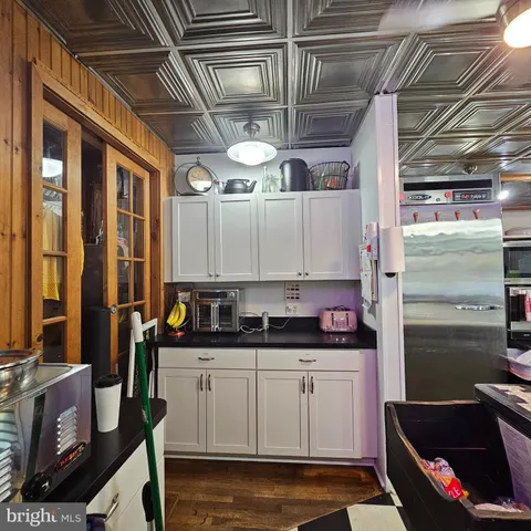 a open kitchen with stainless steel appliances granite countertop a stove a sink and a microwave