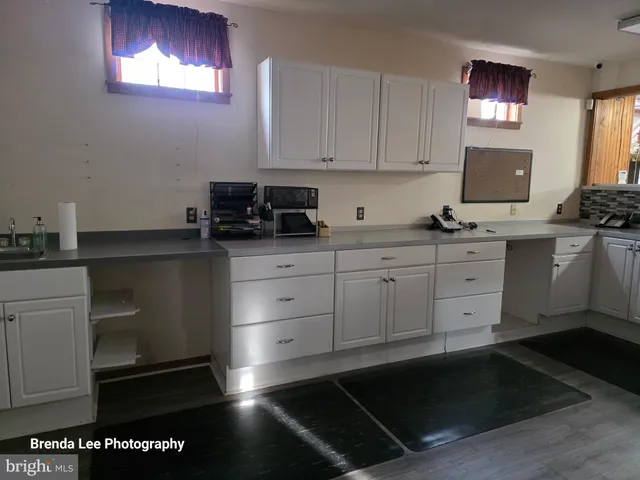 a bathroom with a sink a vanity and a window